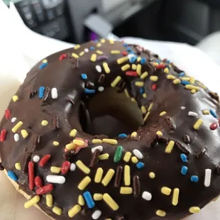 a chocolate frosted donut with sprinkles