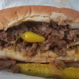 Philly cheesesteak. It comes with mayo, American cheese, onion, chilis and a pickle spear.