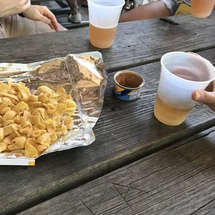 a picnic table full of food and drinks