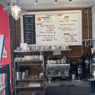 a coffee shop with a menu on the wall