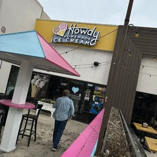 a woman walking past a store