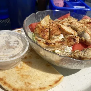 Greek salad with chicken and dressing on the side