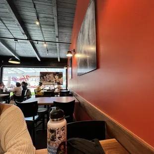 a woman sitting at a table with a water bottle