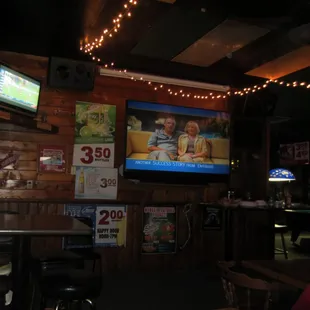 a bar with a television and a pool table