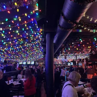 a restaurant decorated with christmas lights