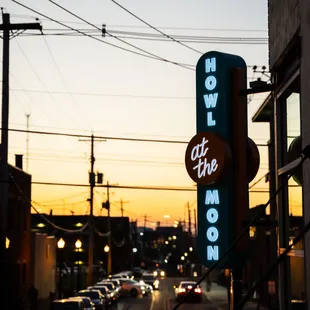 a neon sign for howl the moon