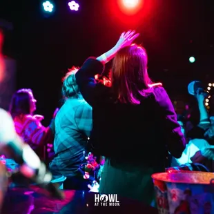 a crowd of people dancing at a party