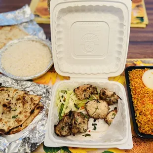 The Spread; Chicken Biryani Rice, Chicken Malai Kebab, Garlic Naan, Butter Naan, and white rice.