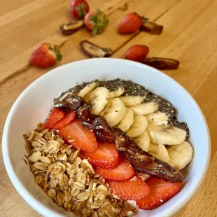 Greek yogurt, banana, strawberries, dates, granola and chia seeds.