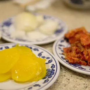 The classic side dishes of pickled radish, onions, and kimchi