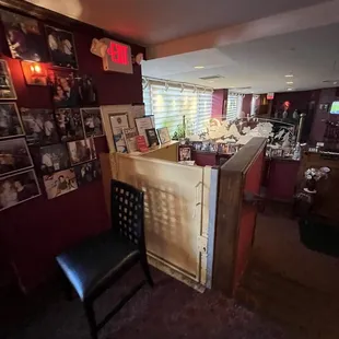 a room with a desk, chair, and pictures on the wall