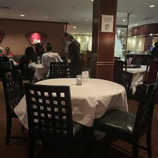 a dining area with tables and chairs