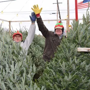 two men in christmas hats and gloves