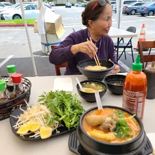 a woman eating a bowl of soup