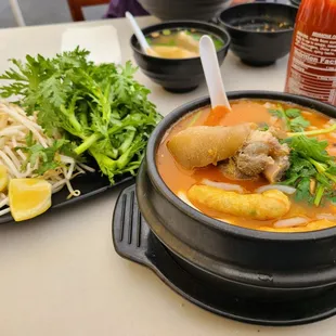 a bowl of soup and a plate of salad