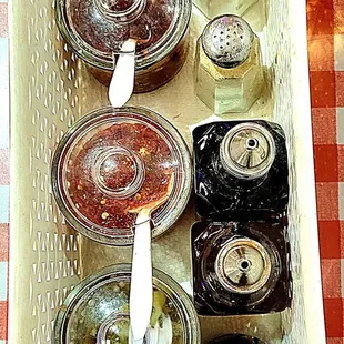 Each table had soy sauce, fish sauce, rice vinegar, black pepper, salt, sliced jalapeños in vinegar, and 2 red chile oils.