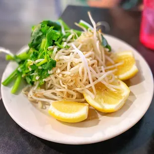 a plate of noodles and lemon slices