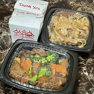 two take out containers of food