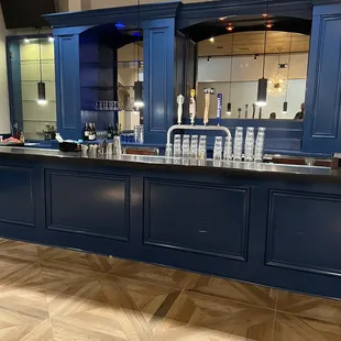 a bar with blue cabinets