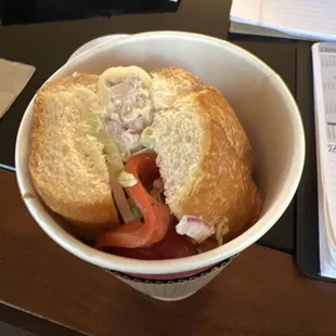 a sandwich in a paper cup