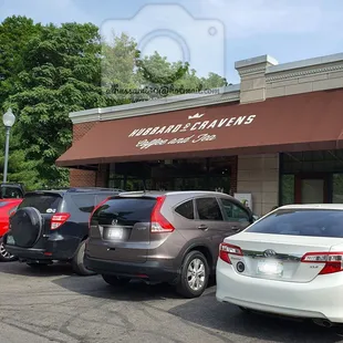 cars parked in front of a coffee shop
