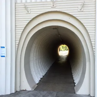 Tunnel from the parking lot to the beer garden. Walk though and follow the path.
