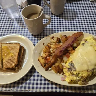 Ham, mushroom and swiss cheese omelette with pan fries and toast.