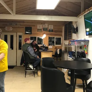 a man in a yellow t - shirt playing a video game
