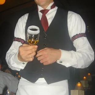 Waiter prepares Kahlua, rum and triple sec, as well as the sugar rim of the Spanish Coffee...