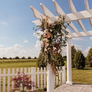 a pergolated arbor with flowers
