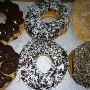 My delicious donuts. Chocolate dipped French Crullers, chocolate frosted with coconut, choc cinnamon, and apricot filled.