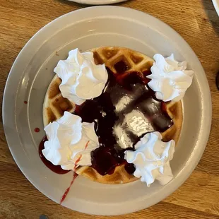 Yummy waffle with strawberries and cream