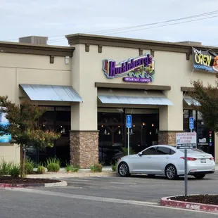 a car parked in front of a restaurant