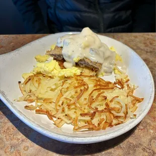 Tom's skillet (split). Chicken Fried steak&amp;gravy, toasted biscuit scrambled eggs,  choice of red skinned potatoes or hashbrowns.
