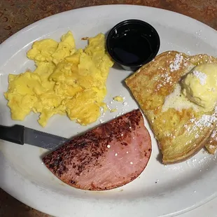 French toast eggs and ham was ok the French toast had too much butter tell them put on side cooked with too much butter Ham was good.