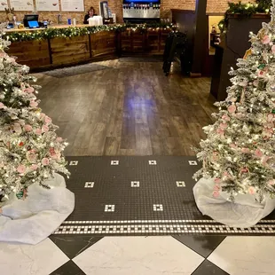 two christmas trees in a lobby