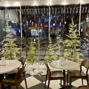 tables and chairs in front of a window