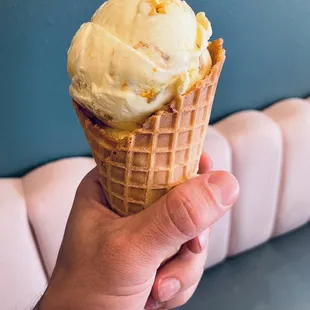 Lemon Bar ice cream in a waffle cone