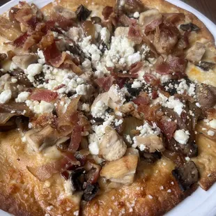 GOAT pretzel pie with bacon, caramelized onions, portobello mushrooms, goat cheese and chicken.