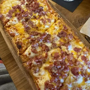 a large rectangular pizza on a cutting board