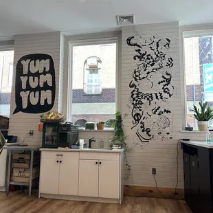 a kitchen with a large mural on the wall