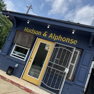 a blue building with a yellow door