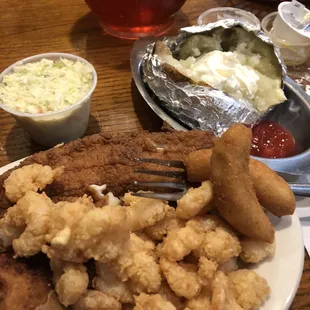 Tilapia, shrimp, deviled crab comes with coleslaw, a baked potato and hushpuppies.