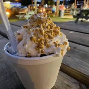 a cup of ice cream topped with nuts