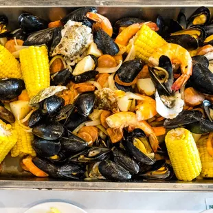 a pan of seafood and corn