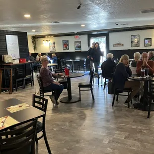 people sitting at tables in a restaurant