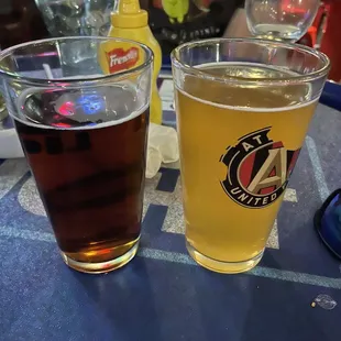 An Amber beer next to a sam Adams wheat beer.