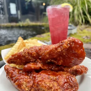 a plate of chicken wings and a drink