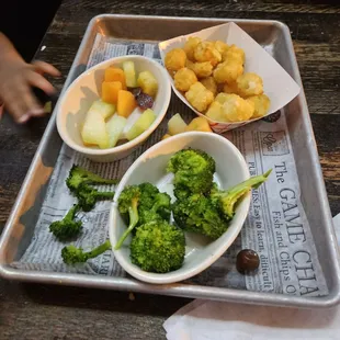 Kids meal with broccoli, tator tots, and mixed fruit. This is after my toddler ate a good bit of food.