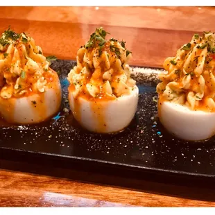 deviled eggs topped with macaroni and cheese